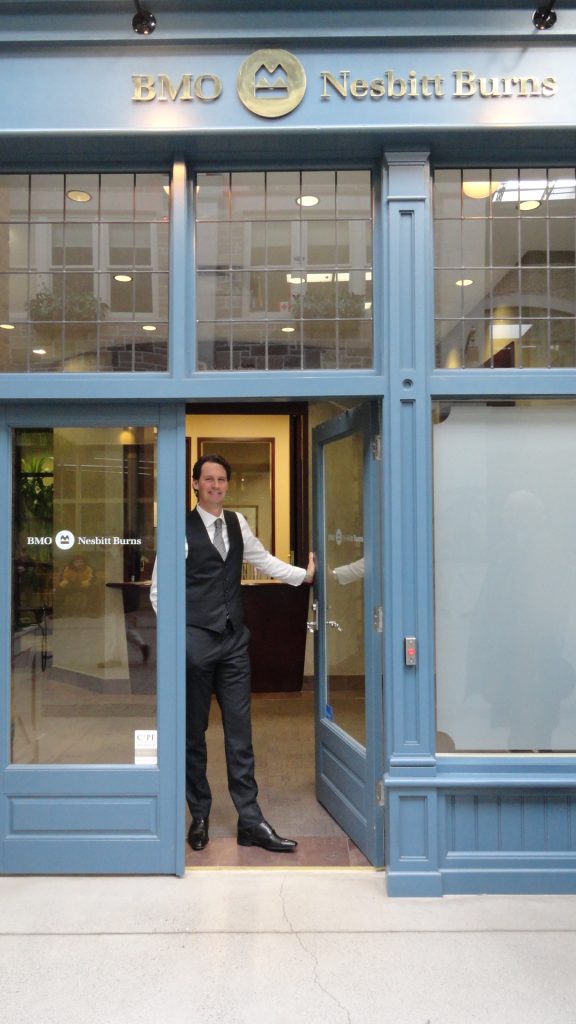 BMO Nesbitt Burns office with a man holding the front door open.