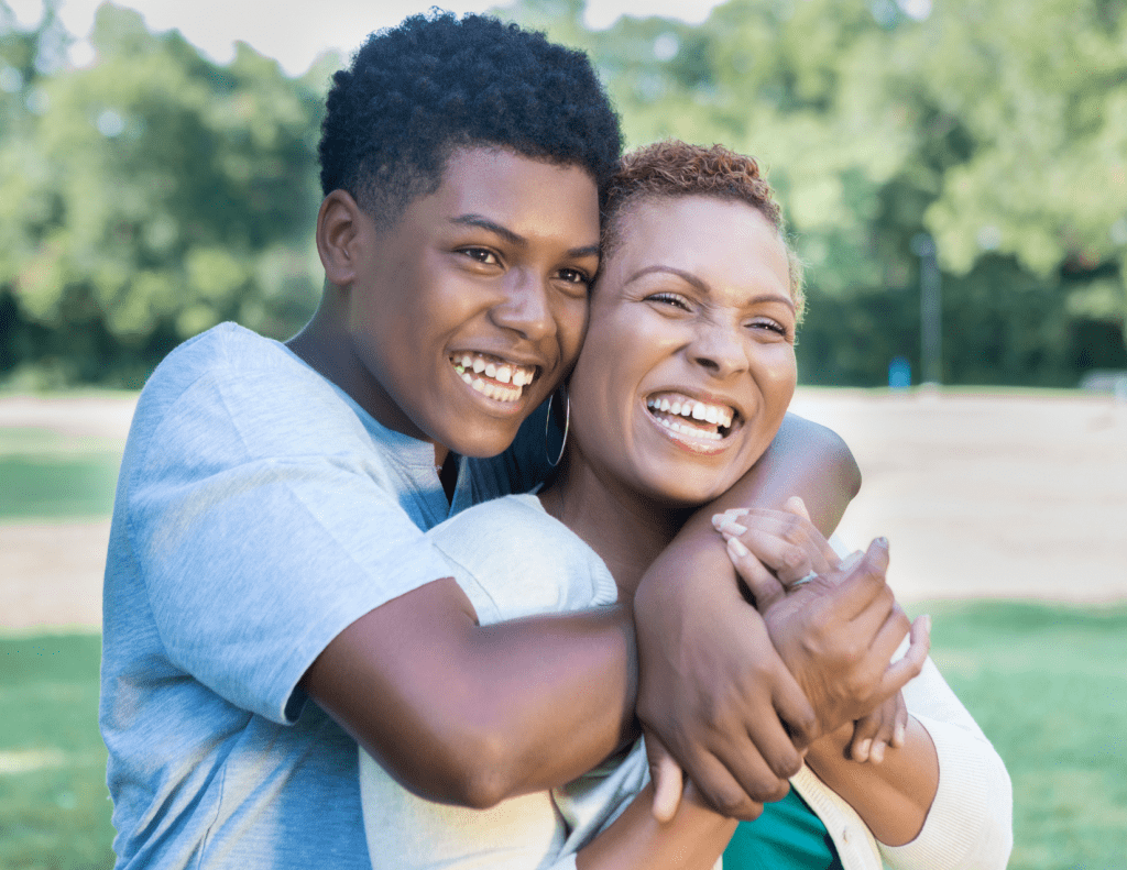 Afroamerican mom & son holding each other